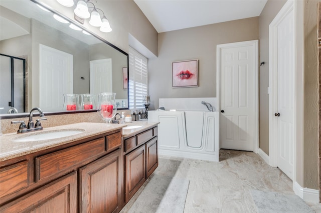 bathroom with vanity and independent shower and bath