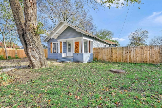 bungalow-style house with a front lawn