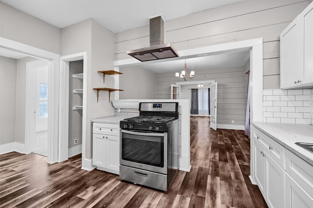 kitchen with white cabinetry, gas range, and island range hood