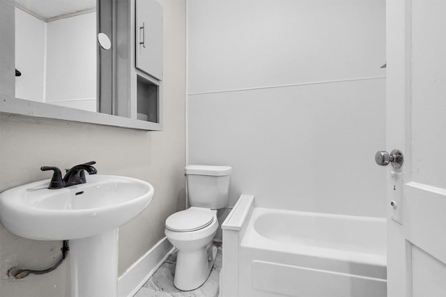 bathroom with a washtub and toilet