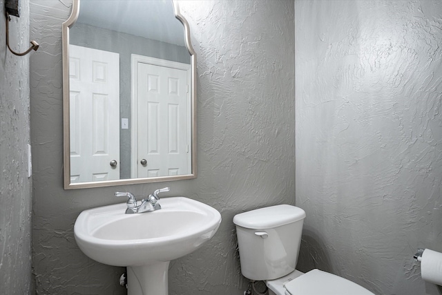 bathroom with toilet and sink