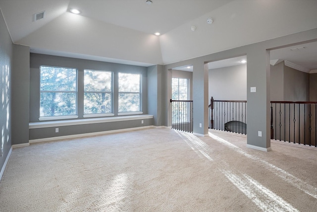 carpeted spare room featuring lofted ceiling