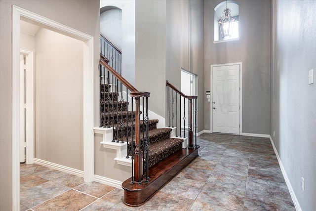 foyer entrance with a high ceiling and a notable chandelier