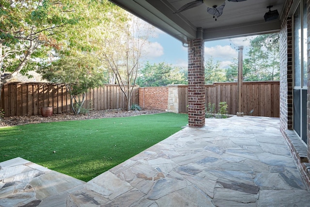 view of yard featuring a patio and ceiling fan