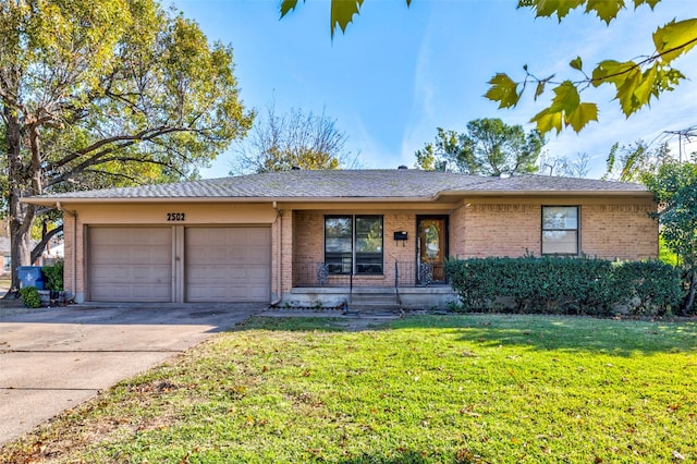 ranch-style home with a front yard, a garage, and covered porch