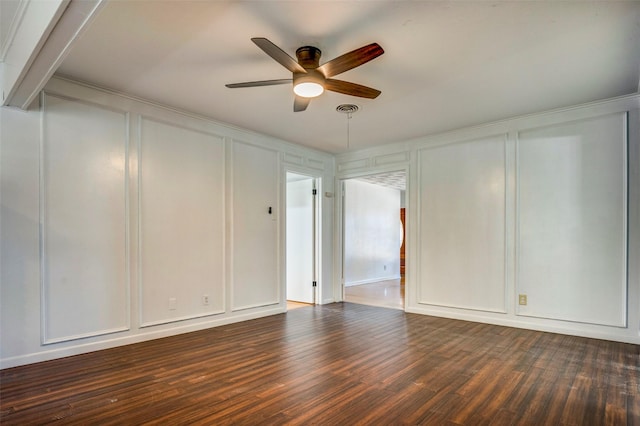 spare room featuring ceiling fan and dark wood-type flooring