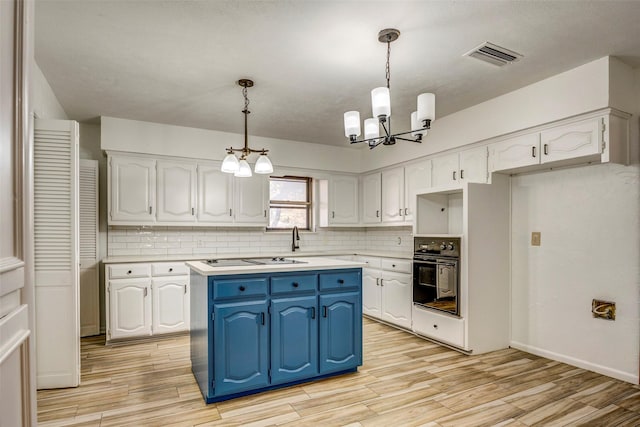 kitchen with blue cabinets, black appliances, a center island, white cabinetry, and hanging light fixtures