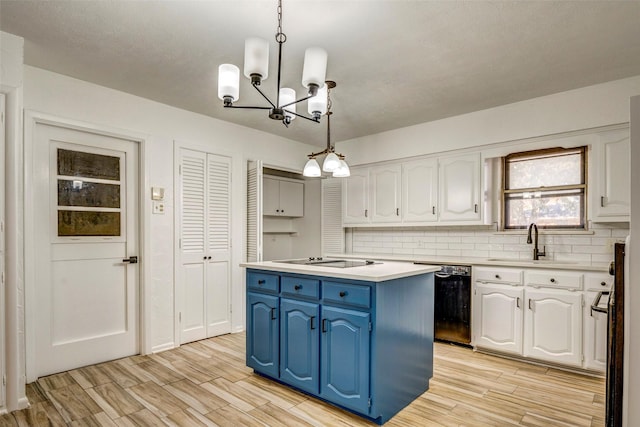 kitchen featuring black appliances, white cabinetry, a kitchen island, and pendant lighting