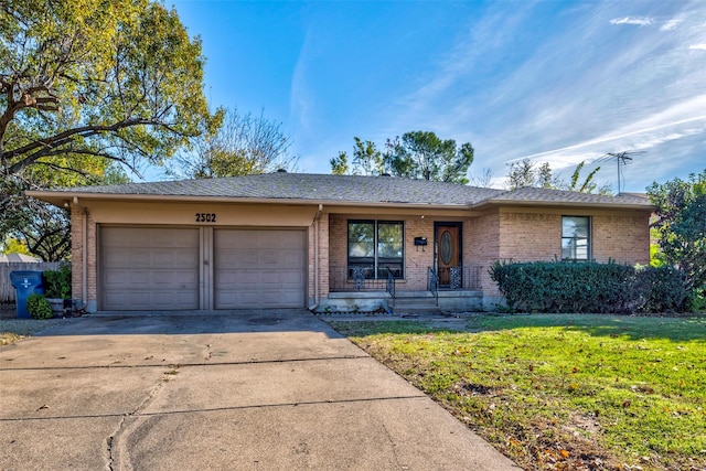 ranch-style home with a garage and a front lawn