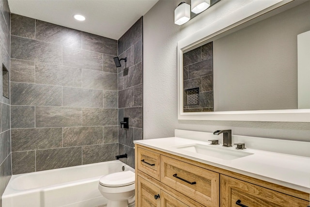 full bathroom with tiled shower / bath combo, toilet, and vanity