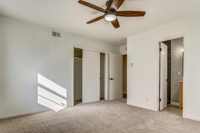 unfurnished bedroom with connected bathroom, ceiling fan, and light colored carpet