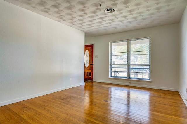 spare room featuring light hardwood / wood-style flooring