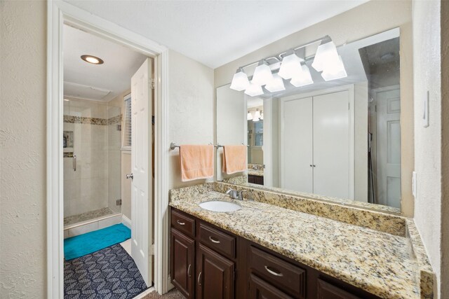 bathroom featuring vanity and a shower with door