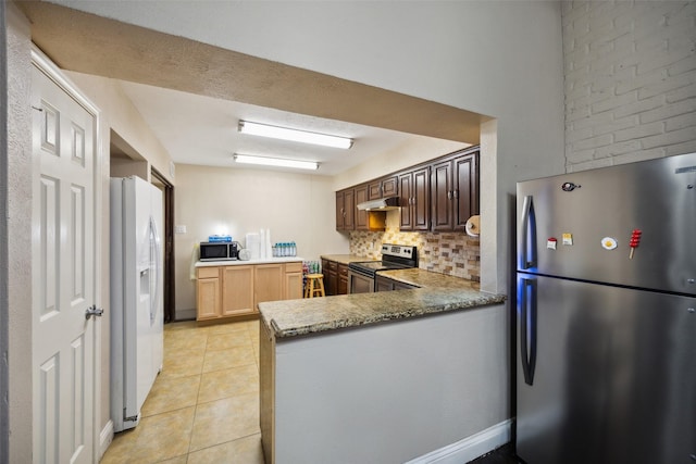 kitchen featuring kitchen peninsula, stainless steel appliances, light tile patterned floors, and tasteful backsplash