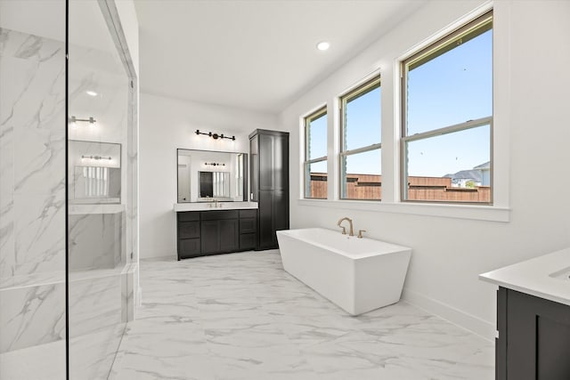 bathroom featuring a tub to relax in and vanity