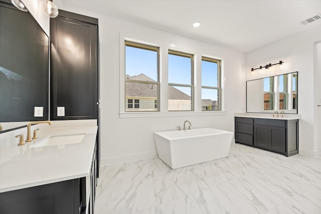 bathroom with a tub to relax in and vanity