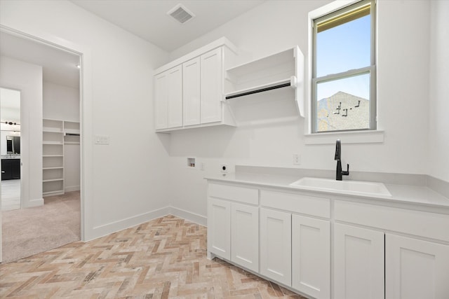 laundry area featuring hookup for an electric dryer, hookup for a washing machine, a healthy amount of sunlight, and sink