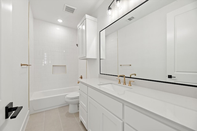 full bathroom featuring tile patterned flooring, vanity, toilet, and tiled shower / bath