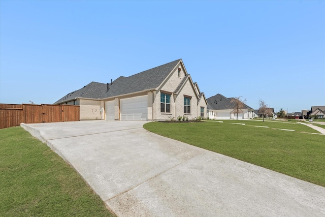 view of front of home featuring a front lawn and a garage