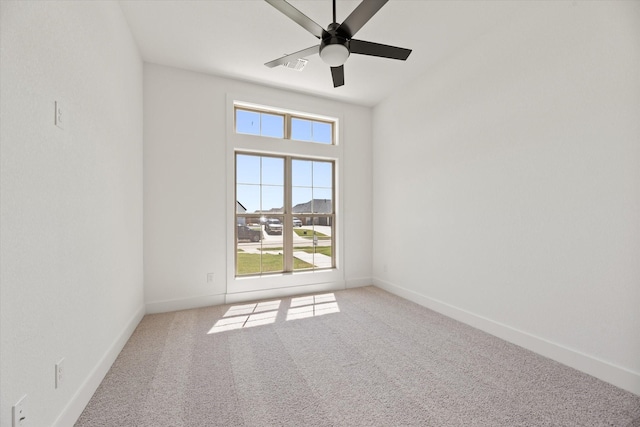 carpeted empty room featuring ceiling fan