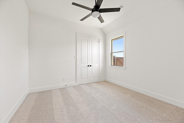 unfurnished room with ceiling fan, carpet floors, and lofted ceiling