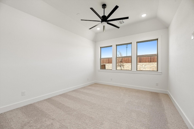 carpeted spare room with ceiling fan and lofted ceiling