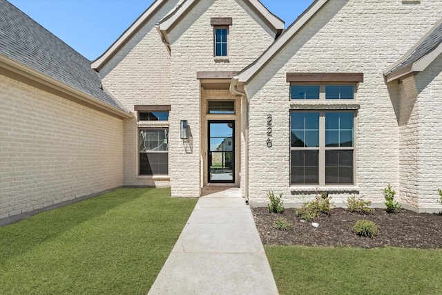 entrance to property with a yard