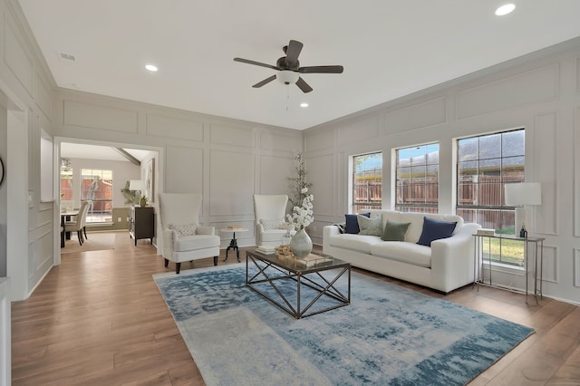 living room with ceiling fan and light wood-type flooring