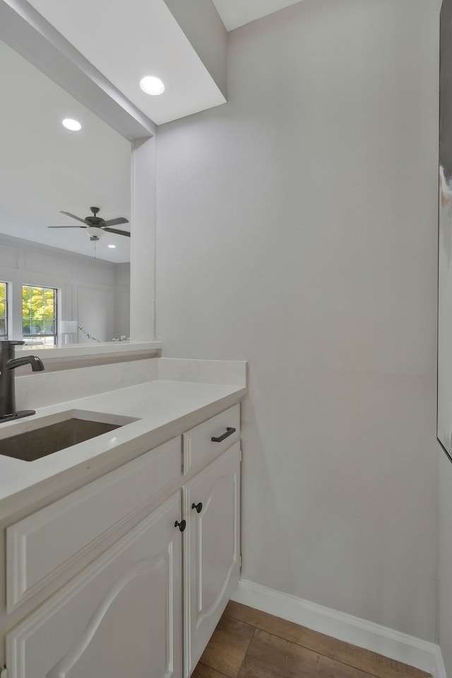 bathroom featuring ceiling fan, vanity, and hardwood / wood-style flooring