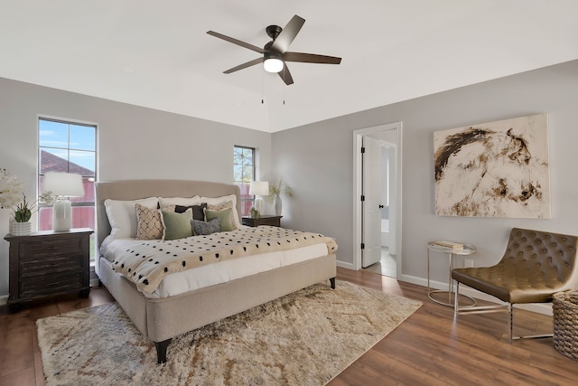 bedroom with multiple windows, ceiling fan, and dark wood-type flooring