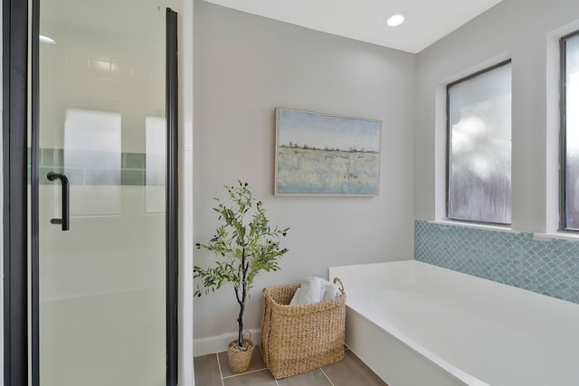 bathroom featuring plus walk in shower and tile patterned flooring