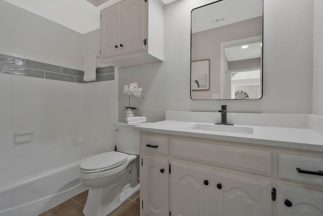 full bathroom featuring washtub / shower combination, tile patterned flooring, vanity, and toilet