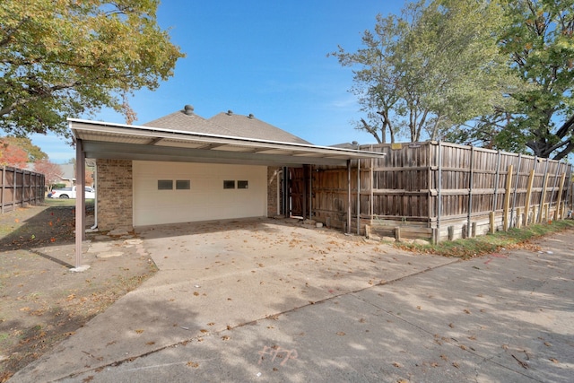 view of home's exterior with a garage and a carport