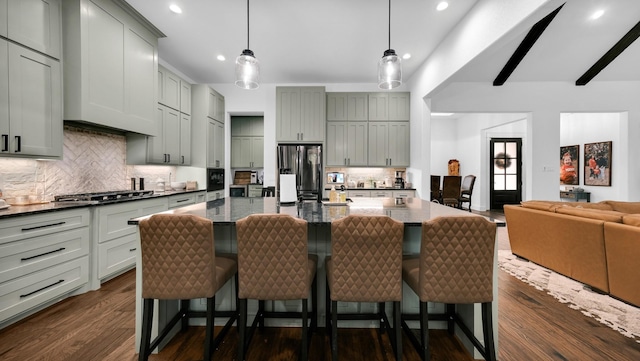 kitchen featuring pendant lighting, a breakfast bar, a spacious island, and dark hardwood / wood-style floors