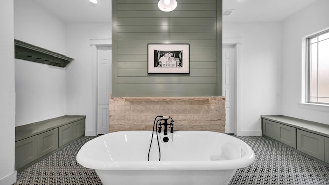 bathroom with tile patterned flooring and a bathtub