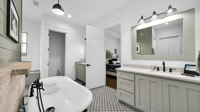 bathroom featuring vanity and a tub to relax in