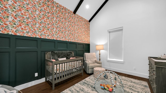 bedroom featuring dark wood-type flooring, high vaulted ceiling, a nursery area, and beamed ceiling