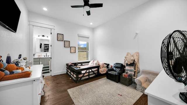 bedroom featuring ensuite bathroom, ceiling fan, and dark wood-type flooring