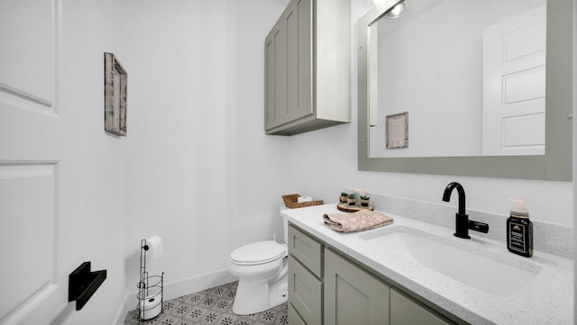 1001 Woodland Rd, Weatherford, TX 76088 - bathroom featuring toilet, vanity, and baseboards
