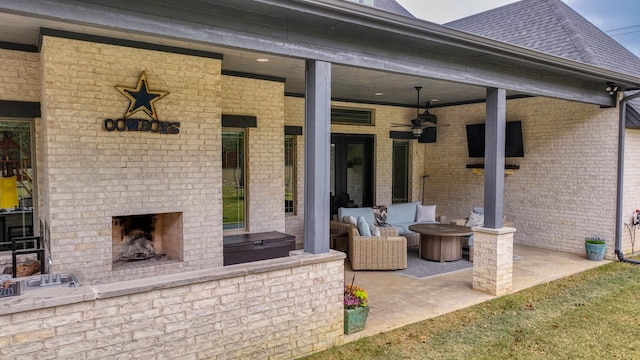 view of patio / terrace featuring an outdoor brick fireplace and ceiling fan