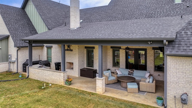 back of house featuring an outdoor hangout area, a patio, and a lawn