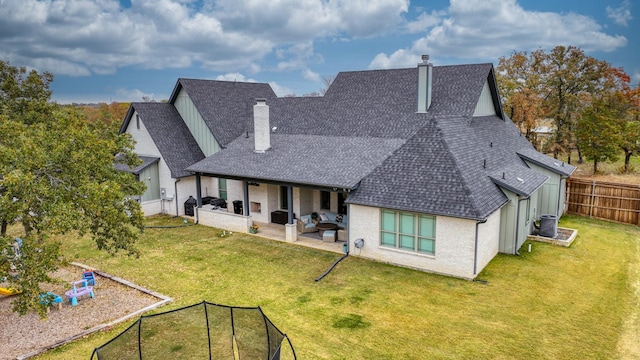 back of house with a lawn, a patio, and an outdoor hangout area