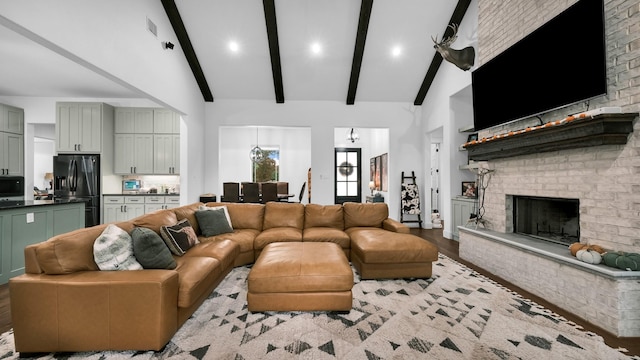 living room with beam ceiling, a fireplace, high vaulted ceiling, and wood-type flooring