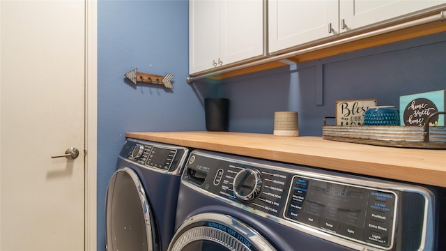 laundry room with washer and clothes dryer and cabinets