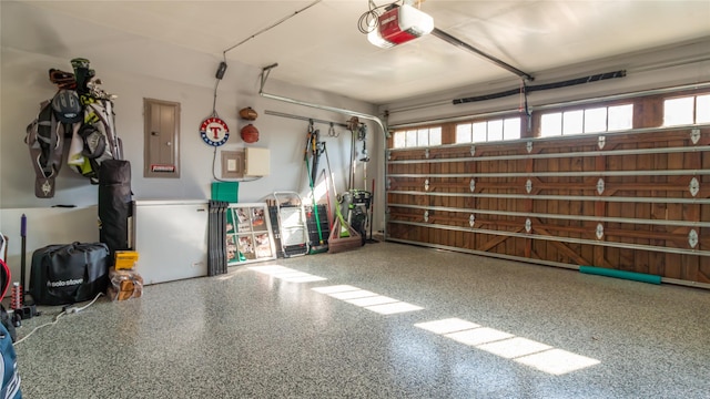 garage with fridge, a garage door opener, and electric panel