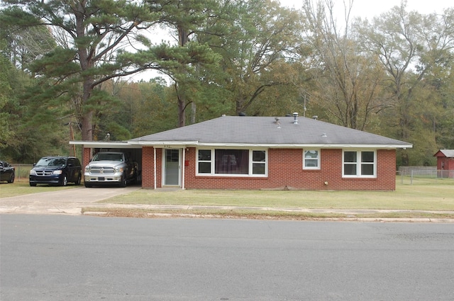 ranch-style house featuring a carport and a front yard