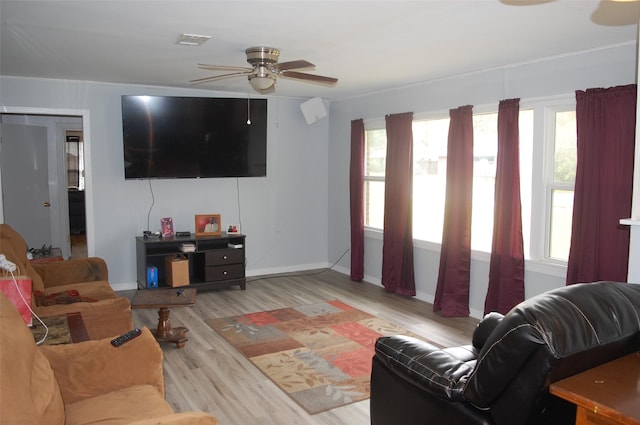 living room featuring ceiling fan and light hardwood / wood-style floors