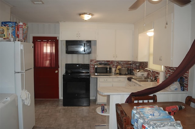 kitchen featuring sink, crown molding, white cabinetry, black appliances, and kitchen peninsula