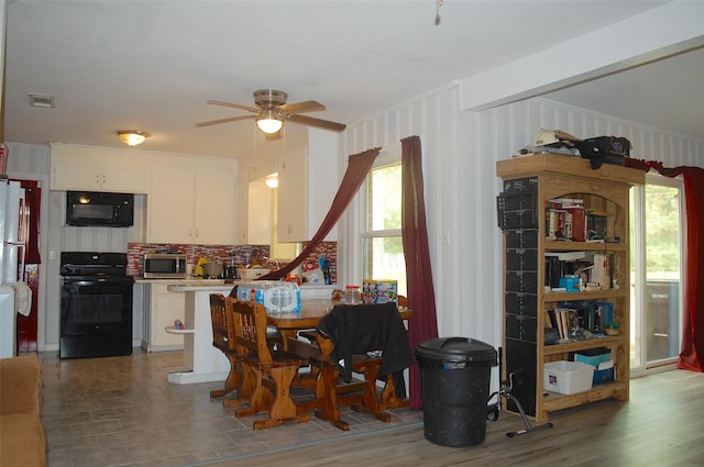 dining space with dark hardwood / wood-style floors and ceiling fan