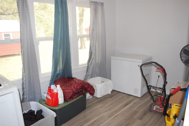 interior space featuring washer / dryer, refrigerator, and light wood-type flooring